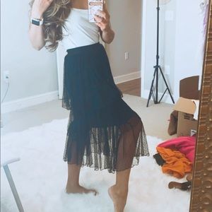 Middy to full length black skirt